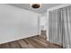 A bright, airy bedroom with wood floors and a doorway to an ensuite bathroom at 2988 Santa Maria Ave, Clermont, FL 34715