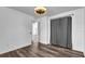 An open bedroom has wood flooring and modern ceiling fan with gray curtain accent at 2988 Santa Maria Ave, Clermont, FL 34715