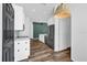 Modern kitchen featuring stainless steel appliances, white cabinetry, and hardwood style flooring at 2988 Santa Maria Ave, Clermont, FL 34715