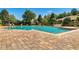 Community pool featuring brick patio and lounge chairs under a clear blue sky at 2988 Santa Maria Ave, Clermont, FL 34715