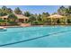 Beautiful community pool featuring lounge chairs, umbrellas, and an adjacent amenity building at 2988 Santa Maria Ave, Clermont, FL 34715