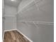 Walk-in closet with hardwood style flooring and wire shelving on gray painted walls at 2988 Santa Maria Ave, Clermont, FL 34715