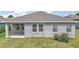 Exterior back view of the home, featuring a covered patio and well-maintained lawn at 3193 Hill Point St, Minneola, FL 34715