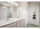 Bright bathroom with double sink vanity and a glass-enclosed shower at 3193 Hill Point St, Minneola, FL 34715