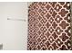 Bathroom featuring a shower with a decorative brown and white patterned shower curtain, and a chrome towel bar at 3193 Hill Point St, Minneola, FL 34715