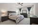 Cozy bedroom featuring a bed with a patterned cover, dresser, and windows at 3193 Hill Point St, Minneola, FL 34715