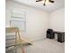 Bright bedroom featuring a window, ceiling fan, desk and ladder for exercise at 3193 Hill Point St, Minneola, FL 34715