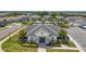 A lush landscape surrounds the community clubhouse with green grass and a blue sky at 3193 Hill Point St, Minneola, FL 34715