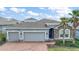 Charming single-Gathering home with three-car garage, stone accents, brick-paved driveway, and well-manicured landscaping at 3193 Hill Point St, Minneola, FL 34715