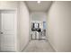 Hallway leading to the living room, featuring an arched entryway and a safety gate at 3193 Hill Point St, Minneola, FL 34715