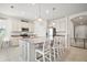 Bright kitchen featuring an island with bar seating, stainless steel appliances, and pendant lighting at 3193 Hill Point St, Minneola, FL 34715