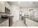 Kitchen with granite countertops, stainless steel appliances, and an island with a sink at 3193 Hill Point St, Minneola, FL 34715