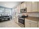 Well-lit kitchen with stainless steel appliances, granite countertops, and a cozy dining area at 3193 Hill Point St, Minneola, FL 34715
