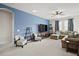 Spacious living room featuring a large sectional sofa and a flat-screen TV at 3193 Hill Point St, Minneola, FL 34715