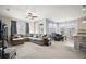 Bright and open living space featuring plush seating, a ceiling fan, lots of natural light, and an open floor plan at 3193 Hill Point St, Minneola, FL 34715