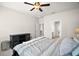 Cozy main bedroom featuring a TV console and an open doorway leading to the ensuite bathroom at 3193 Hill Point St, Minneola, FL 34715