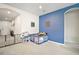 A versatile playroom featuring a blue accent wall and arched doorways at 3193 Hill Point St, Minneola, FL 34715