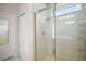 Modern tiled shower with glass door and rainfall shower head in a bright bathroom at 3193 Hill Point St, Minneola, FL 34715