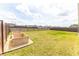 Spacious backyard with a well-maintained lawn, wood fence, and two wooden planter boxes at 3273 Dzuro Dr, Oxford, FL 34484