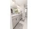 Bathroom featuring a double vanity with marble countertops, framed mirrors, and neutral paint at 3273 Dzuro Dr, Oxford, FL 34484