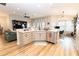 Open concept kitchen featuring stainless steel appliances, stone countertops, and wooden cabinets at 3273 Dzuro Dr, Oxford, FL 34484