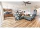 Spacious living room with wood-look flooring, desk, and an open layout into the kitchen at 3273 Dzuro Dr, Oxford, FL 34484