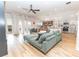 Bright living room with modern ceiling fan, wood-look flooring, and natural light from sliding glass doors at 3273 Dzuro Dr, Oxford, FL 34484