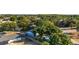 Lovely aerial view of the home with fenced backyard and above-ground pool, surrounded by lush landscaping and mature trees at 36337 Terra Ct, Grand Island, FL 32735