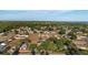 Overhead view of a community featuring cozy homes and green spaces, with a serene lake visible in the distance at 36337 Terra Ct, Grand Island, FL 32735