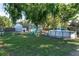 Spacious backyard featuring an above-ground pool, swing set, picnic table, and a well-maintained lawn at 36337 Terra Ct, Grand Island, FL 32735