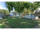 Spacious backyard featuring an above-ground pool, mature trees, and a well-maintained lawn, perfect for summer fun and relaxation at 36337 Terra Ct, Grand Island, FL 32735
