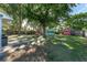 Serene backyard with a picnic area, shed, grill, and lush greenery, ideal for outdoor relaxation and entertainment at 36337 Terra Ct, Grand Island, FL 32735