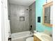 Stylish bathroom featuring tiled shower with built-in niche, wood vanity, and turtle decor at 36337 Terra Ct, Grand Island, FL 32735