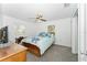 Bedroom with ceiling fan, carpet floors, two windows, and aqua and white walls at 36337 Terra Ct, Grand Island, FL 32735