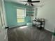 Charming bedroom featuring carpet floors, neutral walls, ceiling fan, and built in bookcase at 36337 Terra Ct, Grand Island, FL 32735