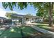 Exterior view of the home showcasing a concrete patio with a grill, complemented by lush greenery at 36337 Terra Ct, Grand Island, FL 32735