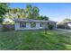 Charming single-story home with a well-kept lawn, grey siding, and a cozy front porch, offering great curb appeal at 36337 Terra Ct, Grand Island, FL 32735