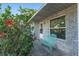 Charming front porch with a decorative bench, blooming hibiscus, and stylish brickwork at 36337 Terra Ct, Grand Island, FL 32735