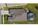 Bird's eye view of a home, showcasing a dark roof, screened-in pool, patio, and a well-maintained yard at 3641 Arlington Ridge Blvd, Leesburg, FL 34748