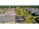 Aerial view of a backyard featuring a screened-in pool, well-manicured lawn, and lush landscaping for outdoor enjoyment at 3641 Arlington Ridge Blvd, Leesburg, FL 34748