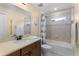 Bathroom featuring a shower-tub combo, neutral tiling, a window, and a modern vanity at 3641 Arlington Ridge Blvd, Leesburg, FL 34748
