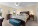 Bedroom featuring a large bed and side tables, illuminated by soft lighting and complemented by a carpeted floor at 3641 Arlington Ridge Blvd, Leesburg, FL 34748