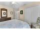 Bright bedroom with a floral-patterned bedspread, complemented by natural light and neutral wall colors at 3641 Arlington Ridge Blvd, Leesburg, FL 34748