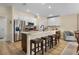 Bright kitchen features a large island with bar seating and modern stainless steel appliances at 3641 Arlington Ridge Blvd, Leesburg, FL 34748
