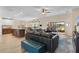 Spacious open-concept living space featuring a gourmet kitchen, large sectional sofa, and patio views at 3641 Arlington Ridge Blvd, Leesburg, FL 34748
