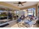 Enjoy the covered patio with comfortable seating, ceiling fan, and views of the pool and backyard, perfect for relaxation and entertainment at 3641 Arlington Ridge Blvd, Leesburg, FL 34748