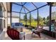 Enjoy the screened-in lanai with ample seating, overlooking a lush lawn, ideal for outdoor relaxation and entertaining guests at 3641 Arlington Ridge Blvd, Leesburg, FL 34748