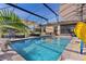 Beautiful screened-in pool surrounded by lush landscaping and outdoor seating, perfect for enjoying the outdoors and entertaining guests at 3641 Arlington Ridge Blvd, Leesburg, FL 34748