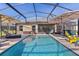 Enjoy the refreshing screened-in pool area, complete with comfortable seating and sun umbrellas for relaxing and entertaining at 3641 Arlington Ridge Blvd, Leesburg, FL 34748