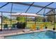Screened-in pool area with patio furniture and lush backyard, perfect for outdoor relaxation and entertainment at 3641 Arlington Ridge Blvd, Leesburg, FL 34748